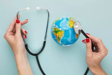 draufsicht-der-hande-die-stethoskop-mit-globus-halten